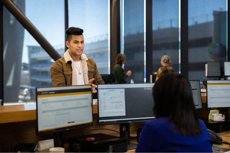 students-speaking-while-using-computers