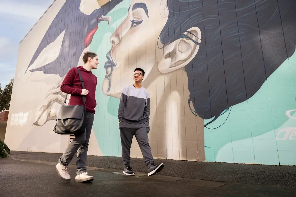 unistart students walking past mural