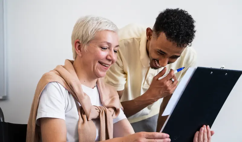 two-people-laughing-at-clipboard-mobile