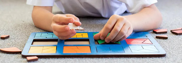 Child completing a block puzzle.