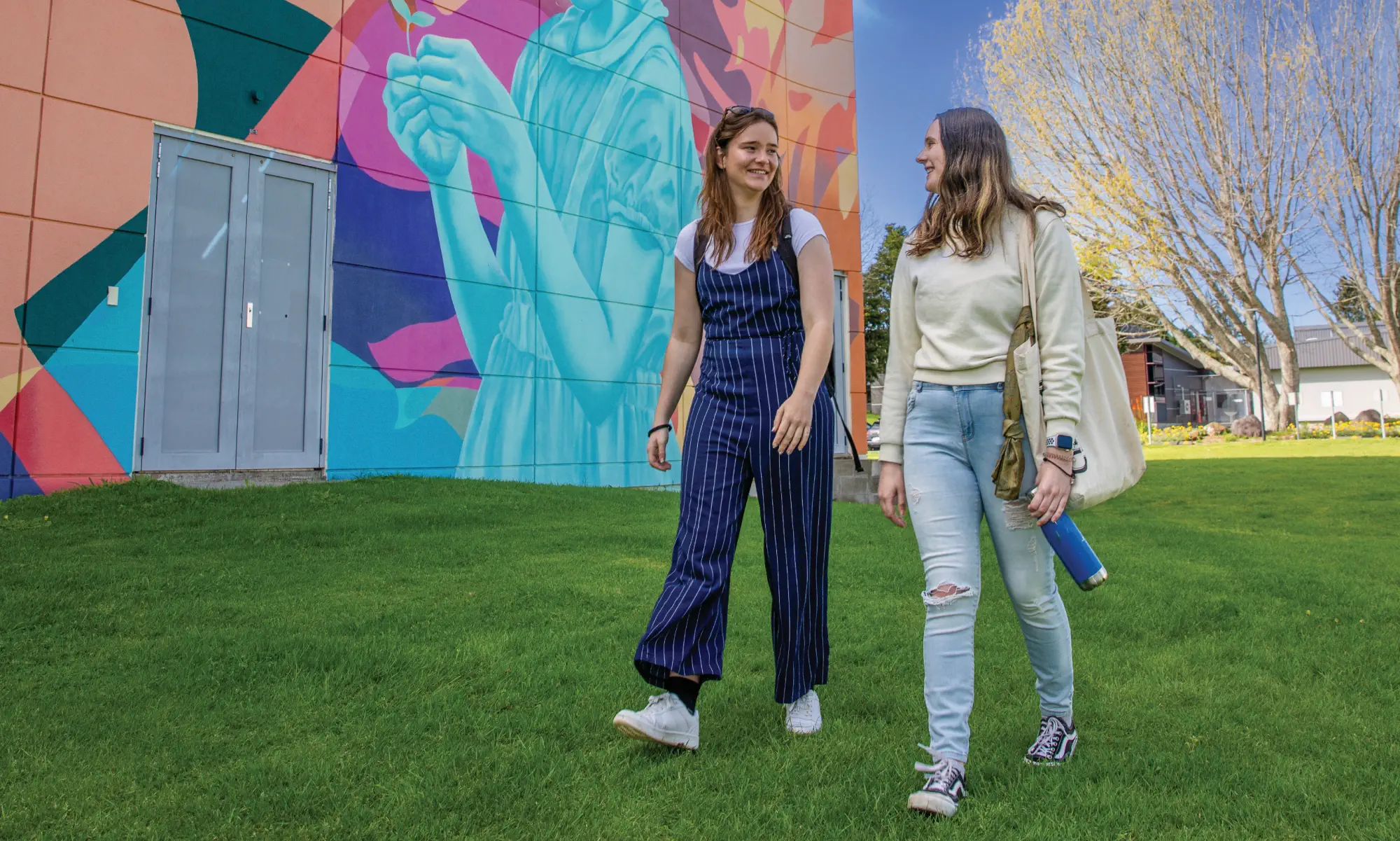 two-students-walking-together-outside